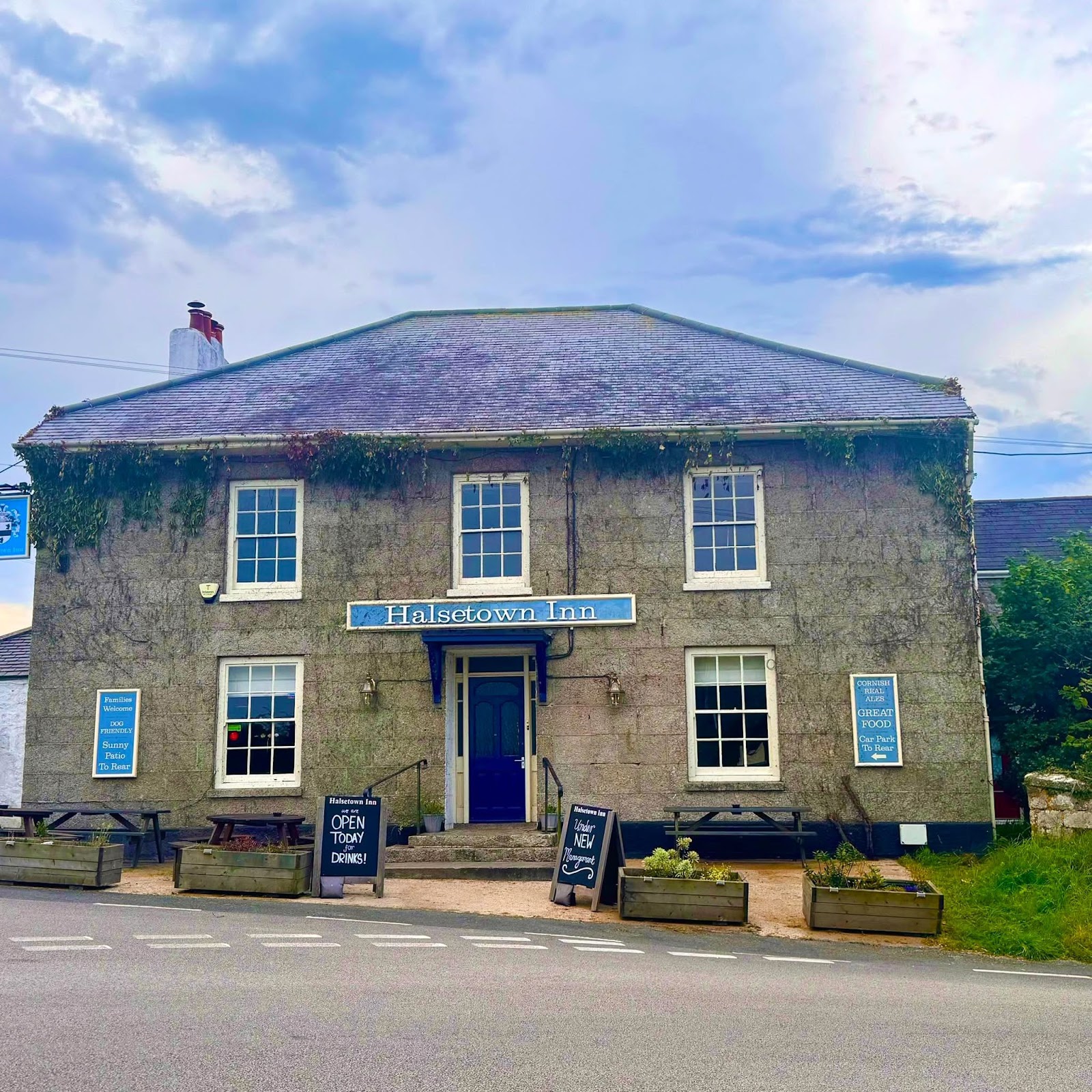 The granite façade of the Halsetown Inn under a blue Cornish sky