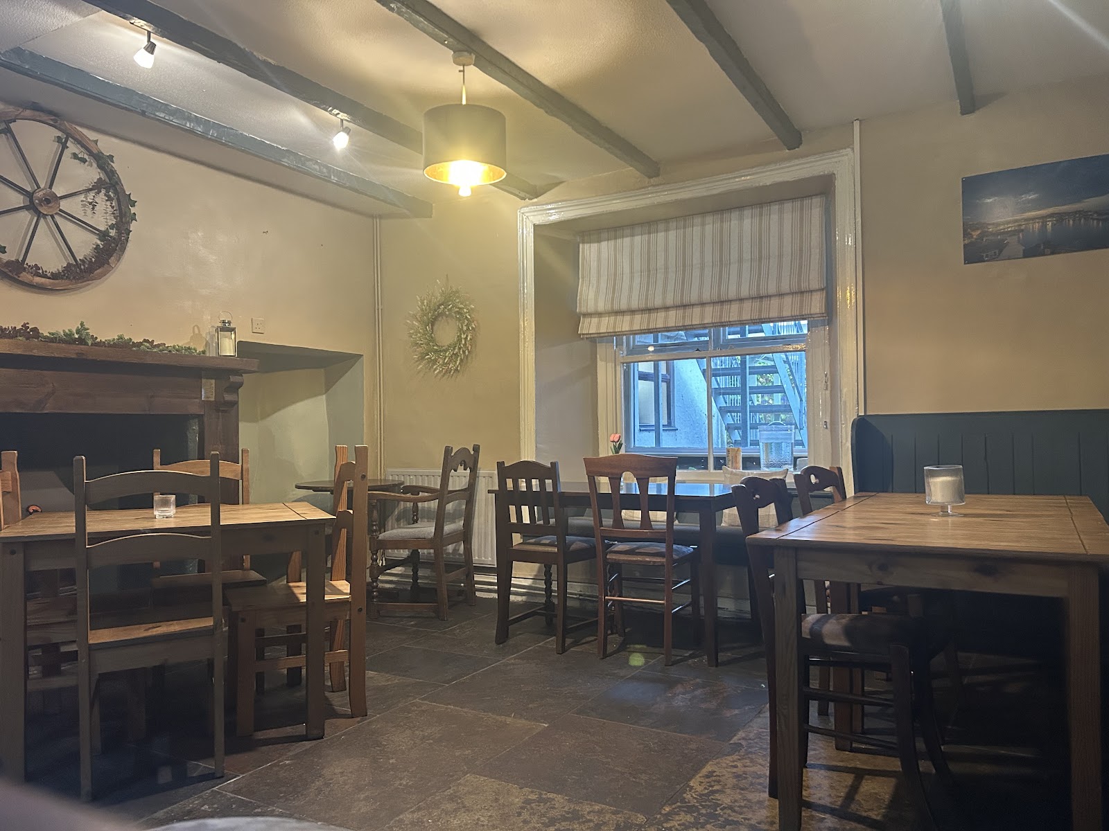The snug, multi-roomed dining room with beams and wooden tables